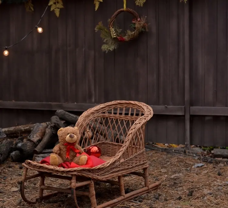 Retro sleigh with basket in the garden as a winter decoration use with teddy
