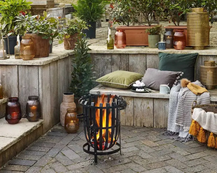 Add appropriate garden decorations for the fall season and an inviting fire pit in the patio area
