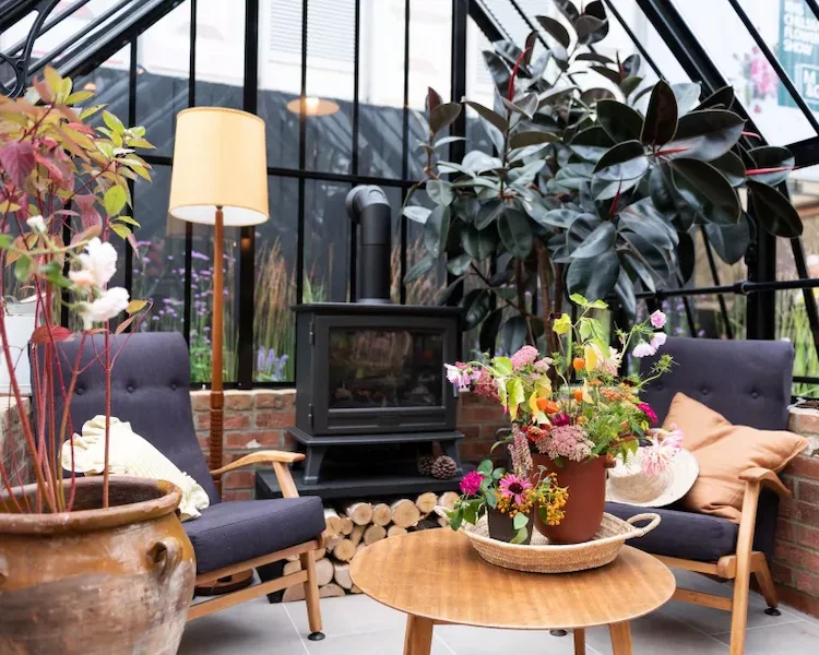 Make a greenhouse instead of a terrace cozy for autumn and winter with a fireplace and plants