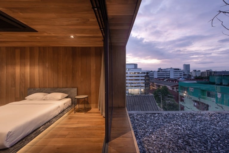 Bedroom with double bed and sliding glass door with view in rooftop apartment
