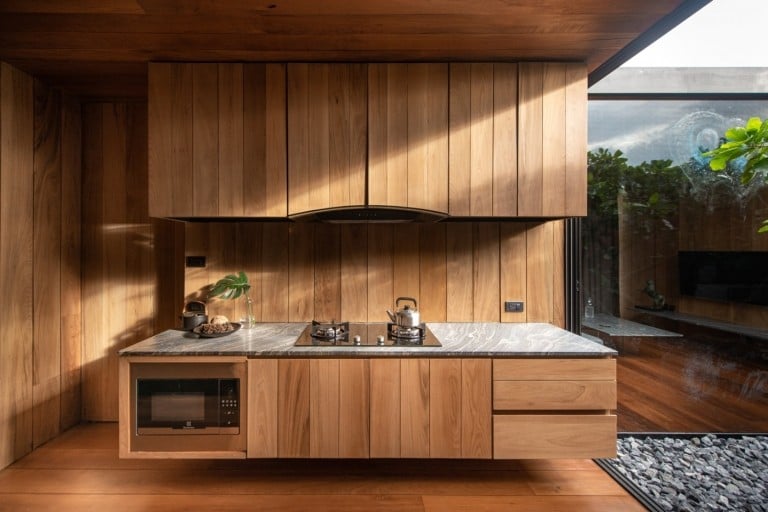 modern fitted kitchen made of wooden materials and kitchen appliances